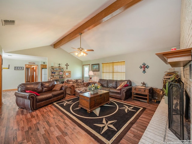 living room featuring vaulted ceiling with beams, ceiling fan, hardwood / wood-style floors, and a brick fireplace