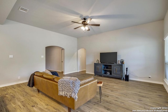 living room featuring ceiling fan and wood-type flooring