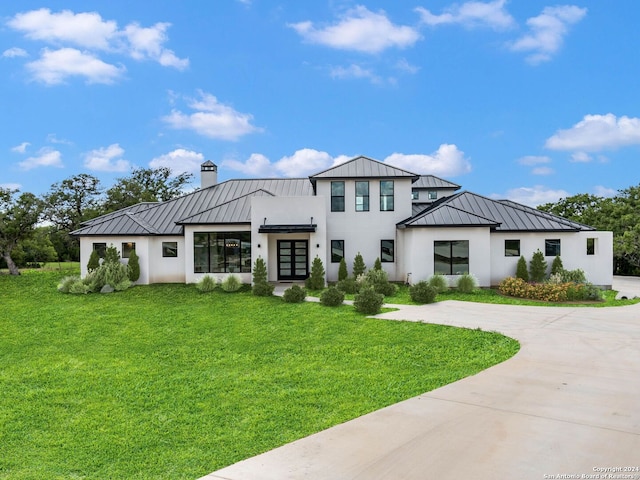 modern inspired farmhouse with a front yard