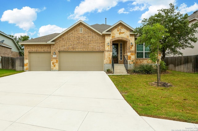 view of front of property with a front yard and a garage