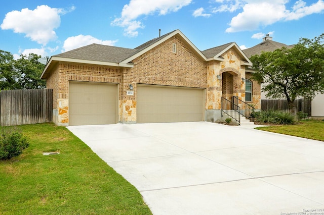 view of front of house featuring a garage and a front yard