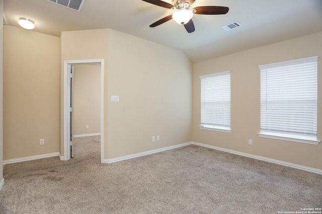 unfurnished room with ceiling fan, light colored carpet, and lofted ceiling