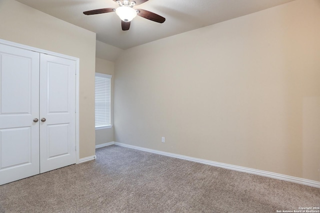 unfurnished bedroom with ceiling fan, a closet, and light carpet