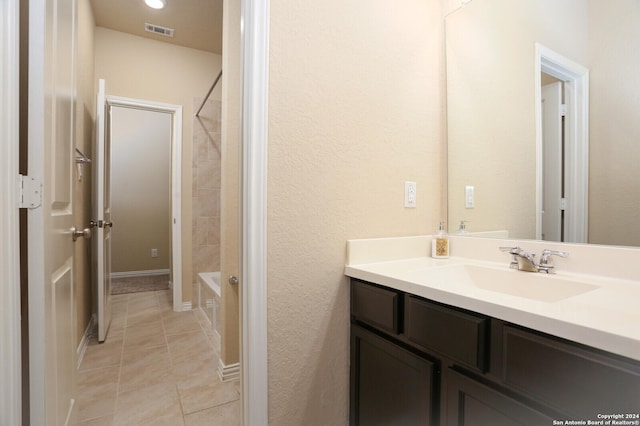 bathroom featuring vanity, tile patterned floors, and tiled shower / bath combo