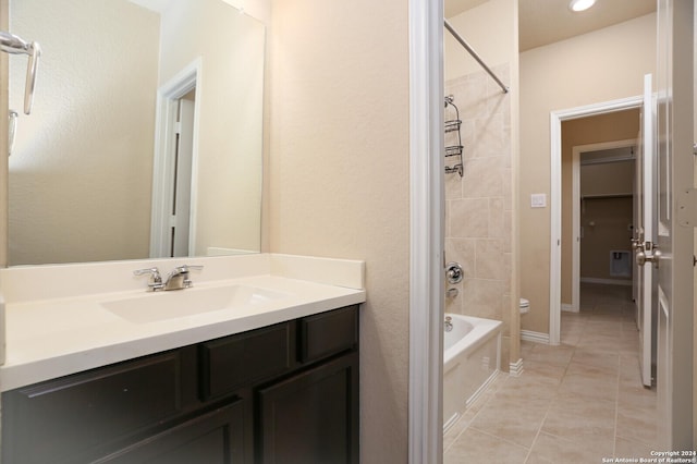 bathroom featuring tile patterned floors, vanity, and tiled shower / bath