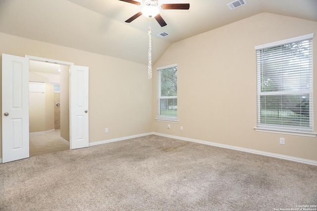 carpeted empty room with ceiling fan and lofted ceiling