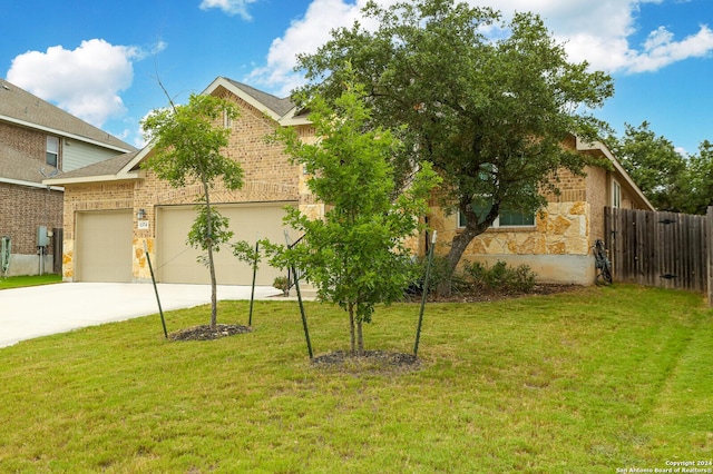 view of front of house featuring a garage and a front lawn