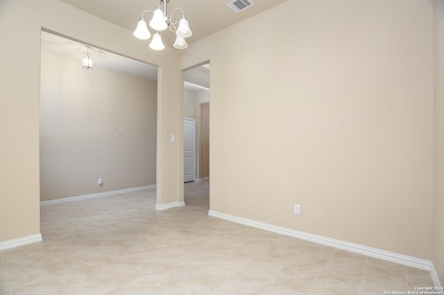 empty room featuring a chandelier