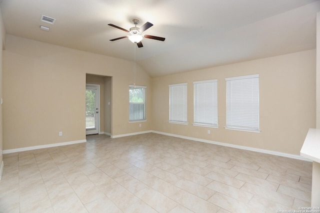 tiled empty room featuring ceiling fan and vaulted ceiling