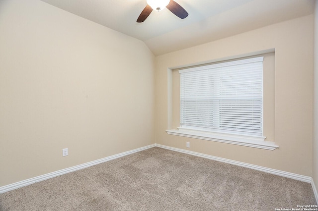 carpeted empty room featuring ceiling fan and lofted ceiling