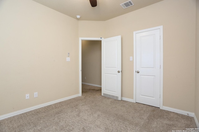 unfurnished bedroom featuring ceiling fan and light carpet