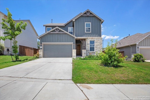 craftsman house with a garage, stone siding, board and batten siding, and a front lawn