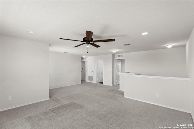 unfurnished room featuring ceiling fan and light colored carpet