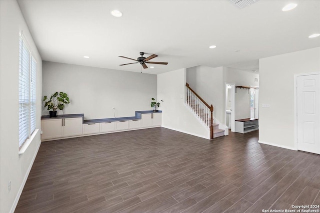 unfurnished living room featuring baseboards, dark wood finished floors, stairway, recessed lighting, and a ceiling fan