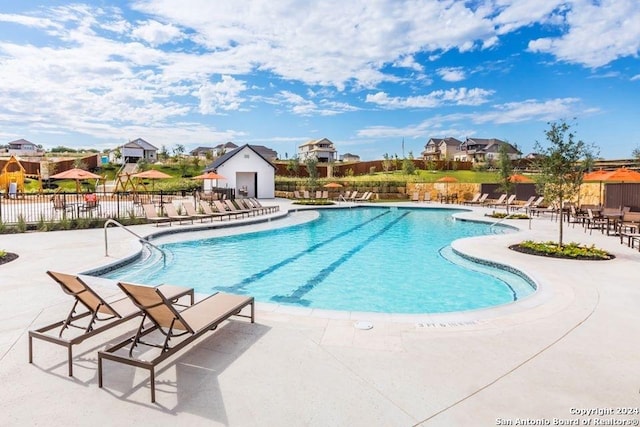 view of swimming pool with a patio area