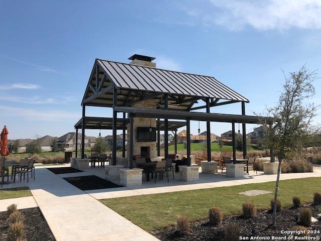 view of home's community featuring a patio and a lawn