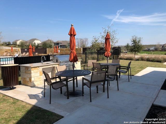 view of patio / terrace with area for grilling, exterior kitchen, and an outdoor wet bar