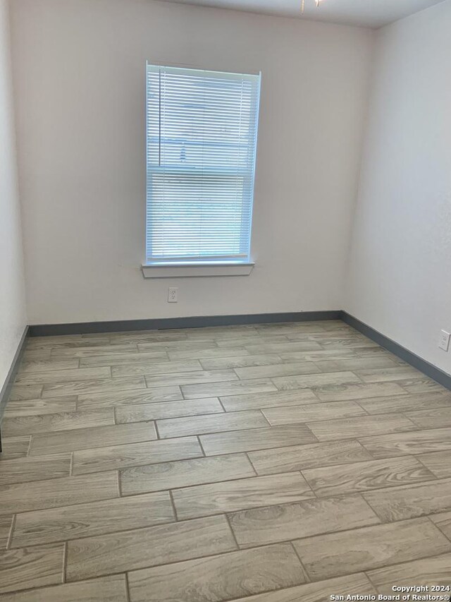 spare room featuring light hardwood / wood-style floors