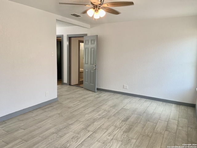 unfurnished room with ceiling fan and light hardwood / wood-style flooring