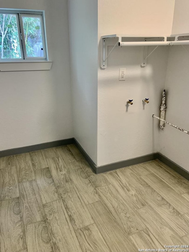 washroom with washer hookup and light wood-type flooring