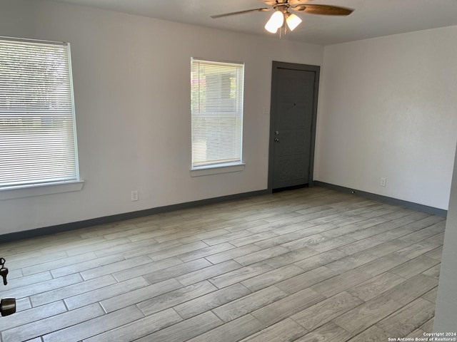 unfurnished room with ceiling fan and light hardwood / wood-style flooring