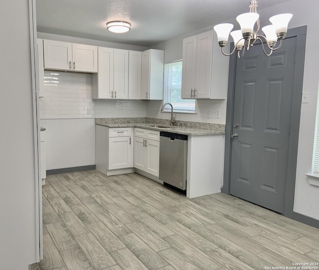 kitchen with sink, white cabinets, dishwasher, and pendant lighting