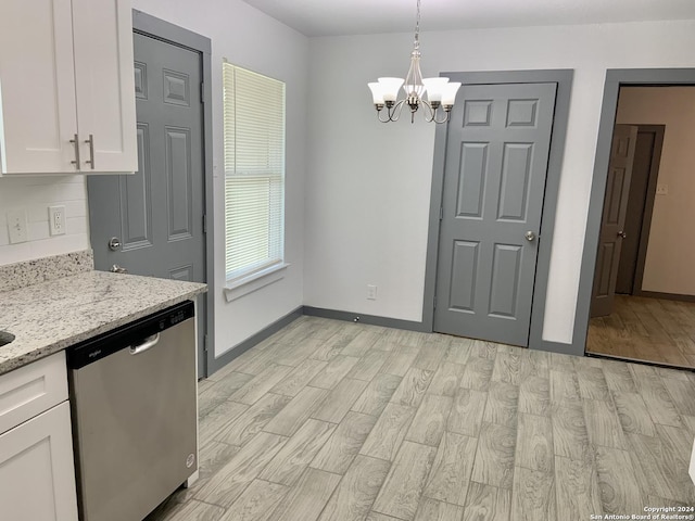 kitchen with light stone counters, stainless steel dishwasher, a chandelier, decorative light fixtures, and white cabinets