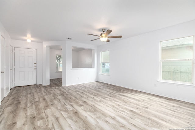 unfurnished living room with ceiling fan and light hardwood / wood-style flooring