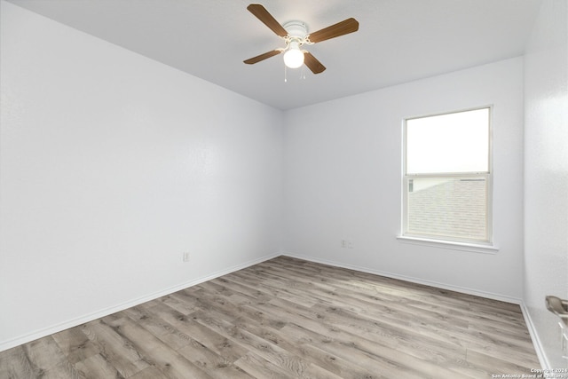 spare room featuring ceiling fan and light hardwood / wood-style flooring