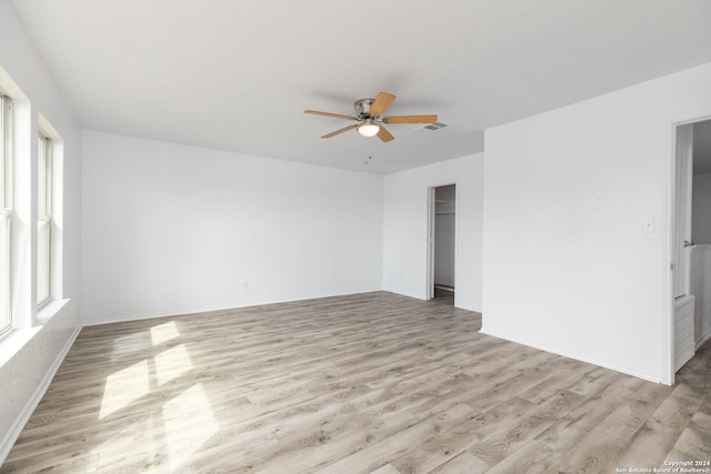 spare room featuring ceiling fan and light hardwood / wood-style floors