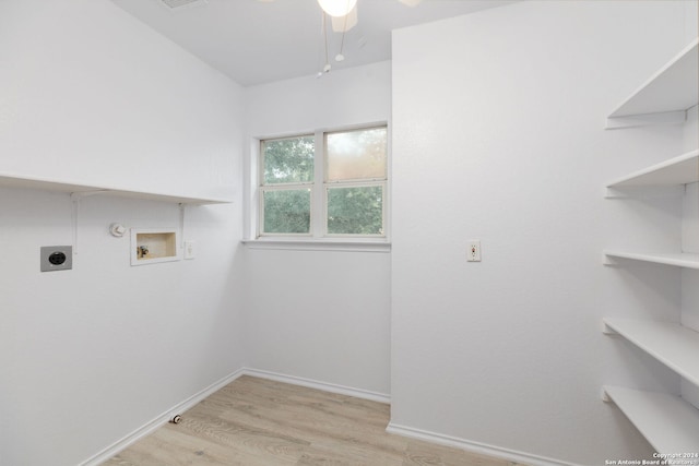 clothes washing area with gas dryer hookup, light hardwood / wood-style floors, hookup for a washing machine, and electric dryer hookup