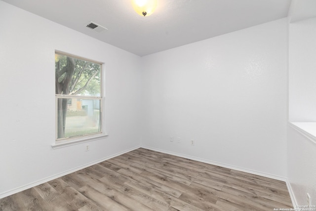 unfurnished room with light hardwood / wood-style flooring