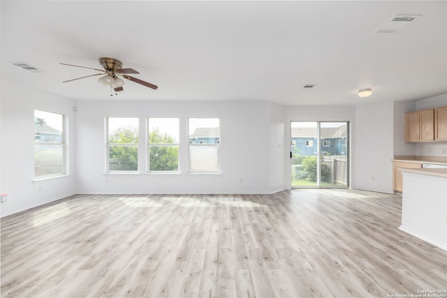 unfurnished living room with light hardwood / wood-style flooring and ceiling fan