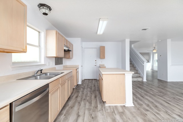 kitchen featuring sink, light hardwood / wood-style floors, a kitchen island, stainless steel dishwasher, and light brown cabinets