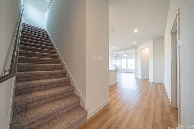 10286 Bartenheim Dr, Schertz, TX 78154 - stairs with wood finished floors, ceiling fan, recessed lighting, and baseboards