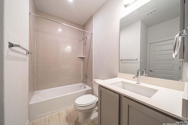 10286 Bartenheim Dr, Schertz, TX 78154 - bathroom with toilet, wood finished floors, vanity, washtub / shower combination, and a textured wall