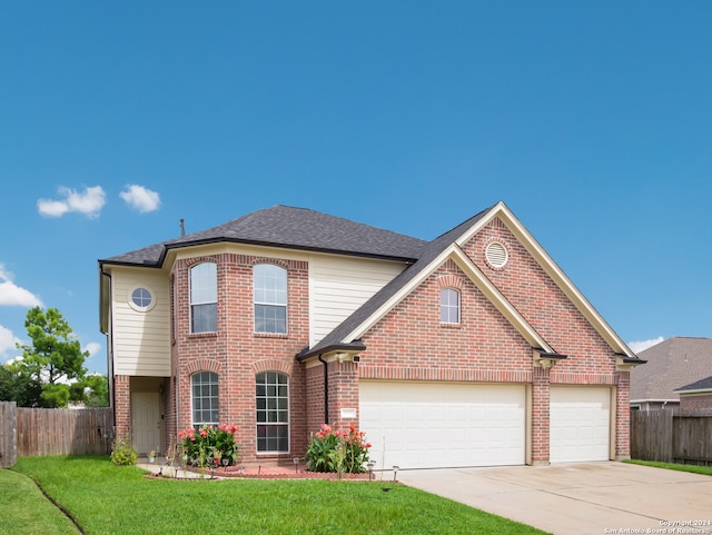 front facade featuring a garage and a front yard