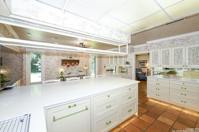 kitchen featuring tile patterned floors and white cabinetry