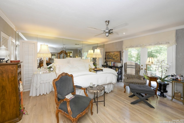 bedroom with ceiling fan, light wood-type flooring, and crown molding