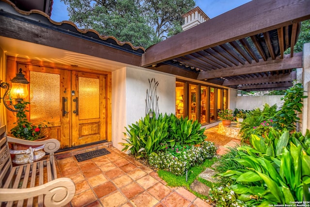 entrance to property with a pergola and french doors