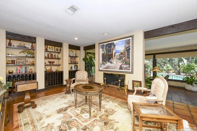 living area featuring tile patterned floors and built in features