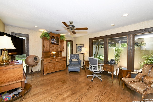 living area featuring ceiling fan and hardwood / wood-style floors