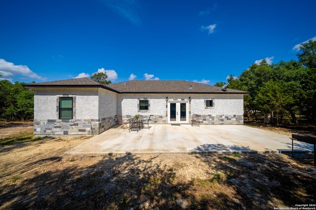 rear view of house featuring a patio and french doors