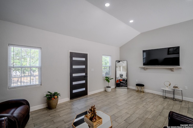 foyer entrance with lofted ceiling, baseboards, wood finished floors, and recessed lighting