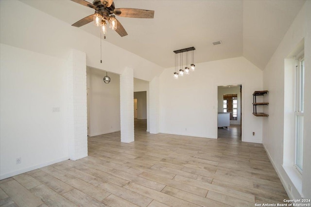 unfurnished room with ceiling fan, vaulted ceiling, and light hardwood / wood-style floors