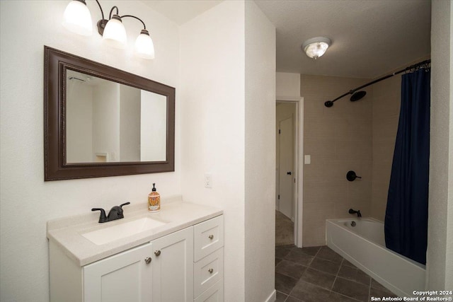 bathroom featuring shower / bathtub combination with curtain, tile patterned floors, and vanity