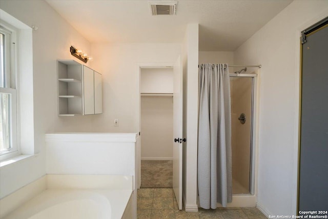 bathroom featuring independent shower and bath