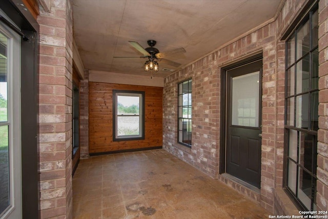 interior space with ceiling fan