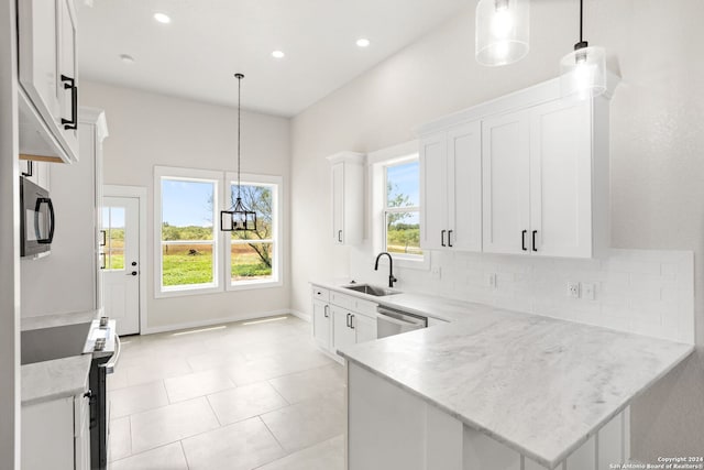 kitchen with white cabinetry and pendant lighting