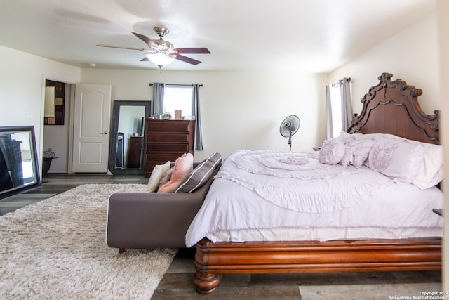 bedroom with dark hardwood / wood-style floors and ceiling fan